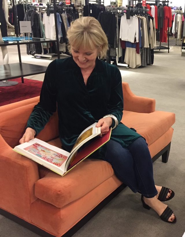 perusing a scarf book while shopping