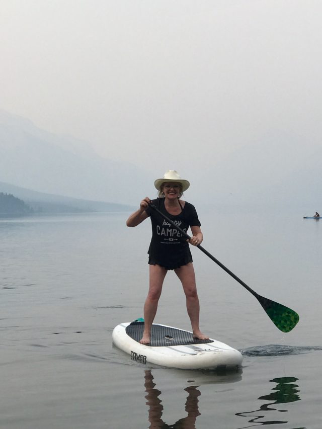 Jennifer Connolly of A well Styled life paddle boarding in Montana