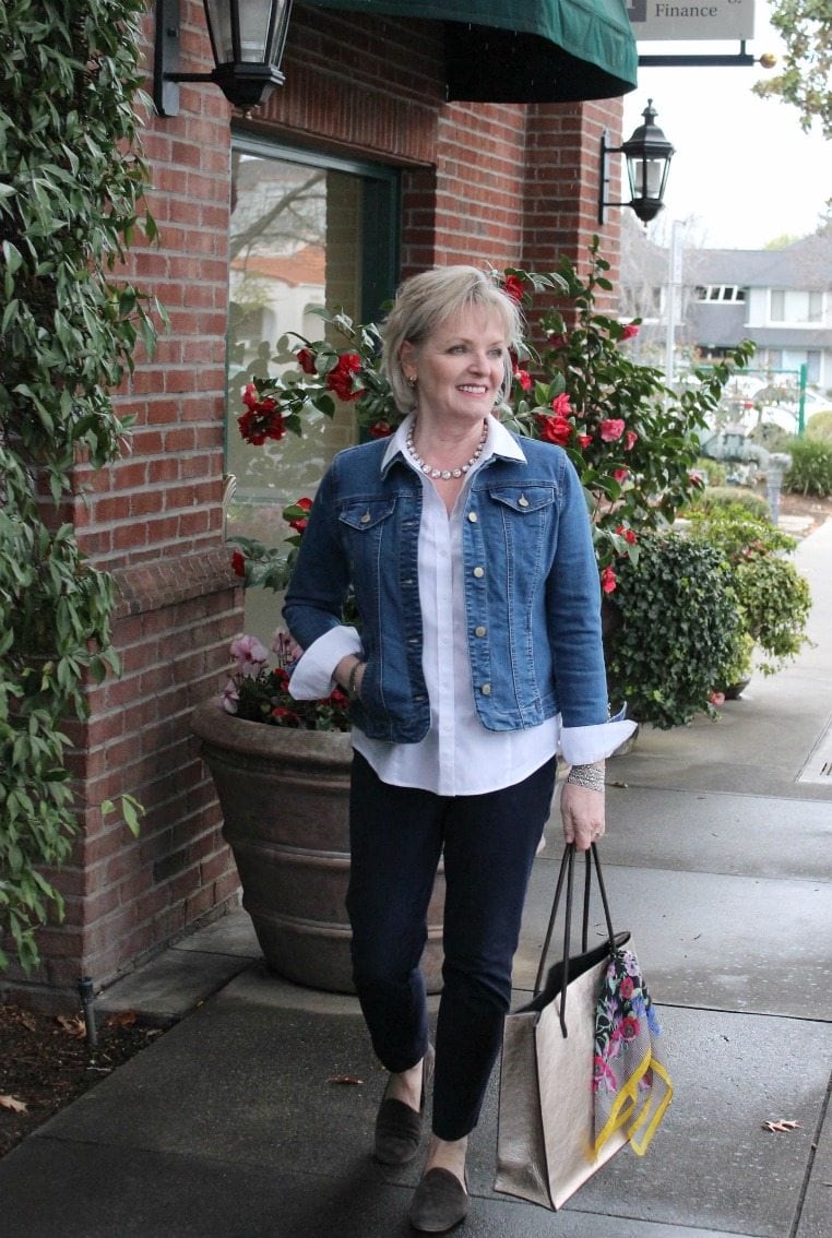 Jennifer Connolly of A Well Styled Life wearing casual outfit of denim jacket and slim blue pants