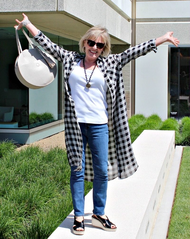 Jennifer Connolly of A Well Styled Life modeling black and ivory long plaid silk shirt with jeans and sandals