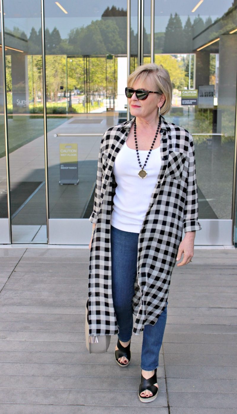 Jennifer Connolly of A Well Styled Life modeling black and ivory long plaid silk shirt with jeans and sandals