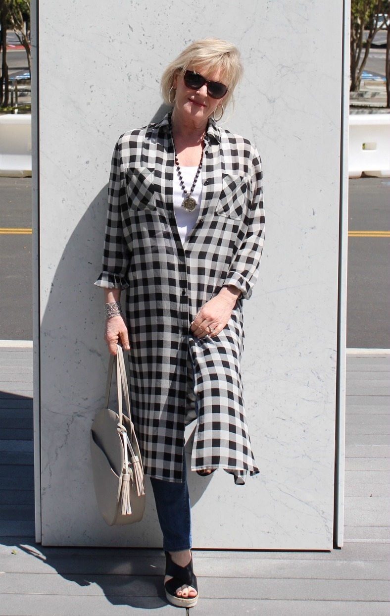 Jennifer Connolly of A Well Styled Life modeling black and ivory long plaid silk shirt with jeans and sandals