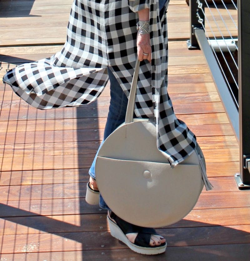 Jennifer Connolly of A Well Styled Life modeling black and ivory long plaid silk shirt with jeans and sandals