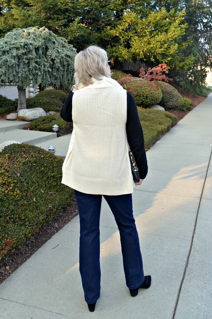 the ribbed knit back of sherpa vest and boot cut jeans on A Well Styled Life
