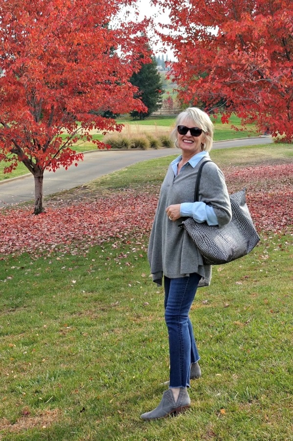Jennifer Connolly of A Well Styled Life wearing double denim and a cashmere poncho