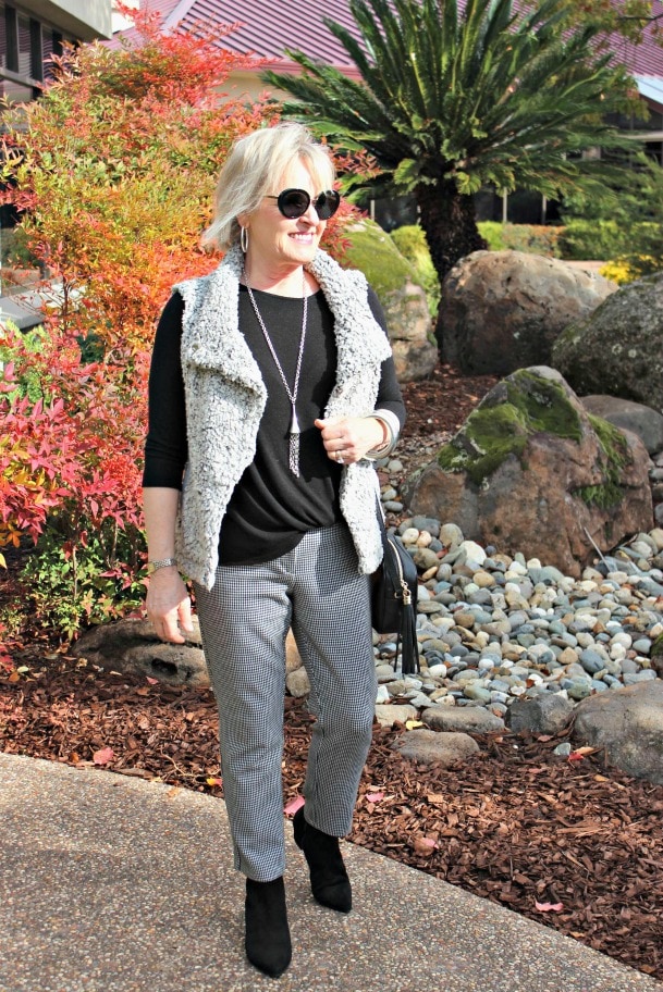 jennifer connolly of a well styled life styling gray mini check pants with black sweater and booties