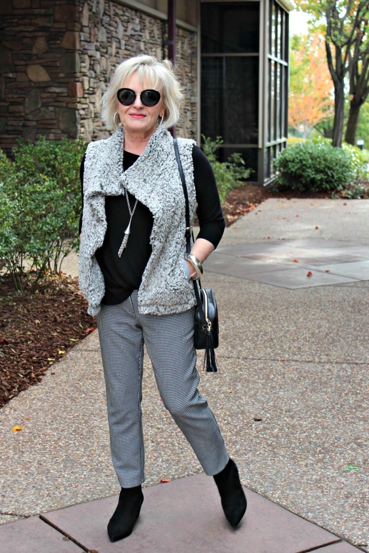 Jennifer Connolly of A Well Styled life wearing gray vest over black and white gingham, slacks