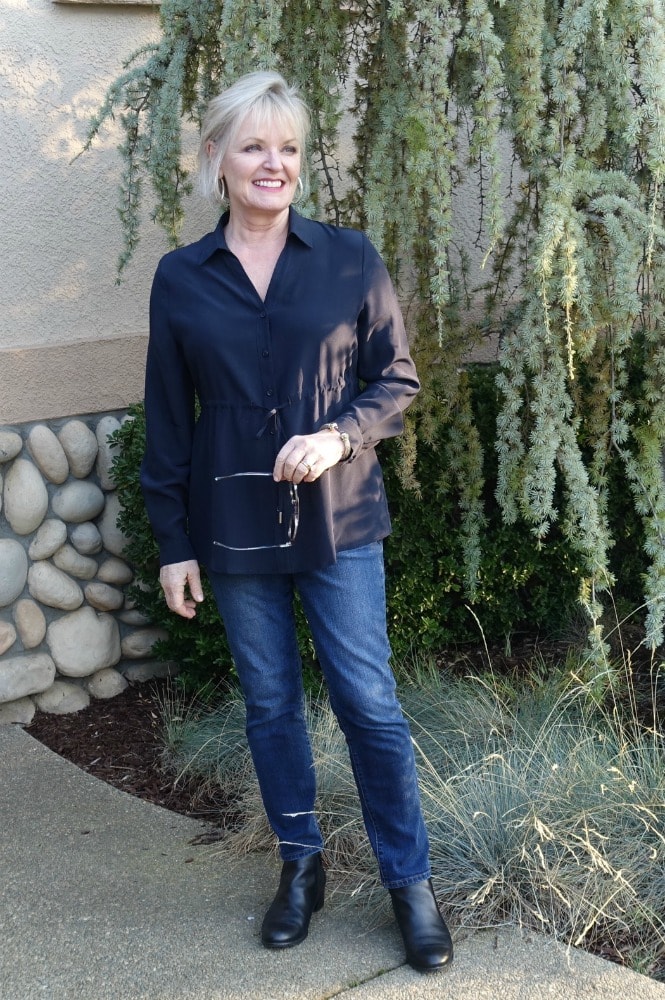 Style blogger Jennifer Connolly wearinf navy silk bloiuse with jeans and black boots