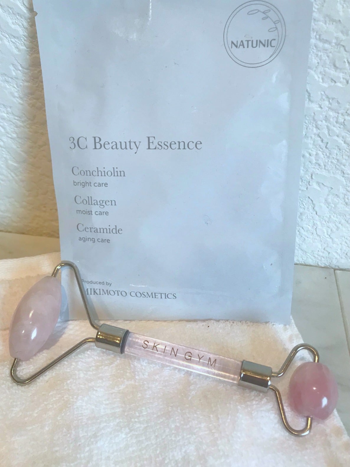rose quartz roller and sheet mask on a well styled life