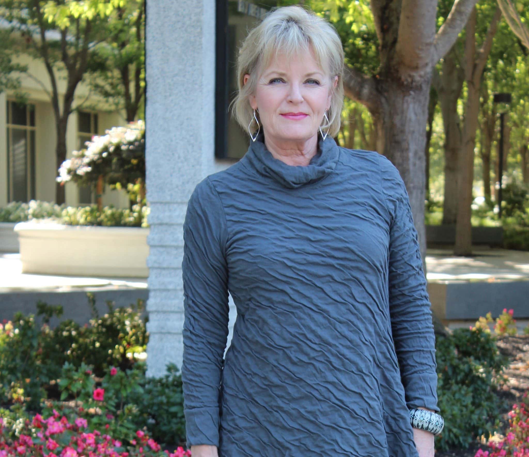 Jennifer Connolly of A Well Styled Life wearing a textured tunic which helps smooth the look of lines on your face