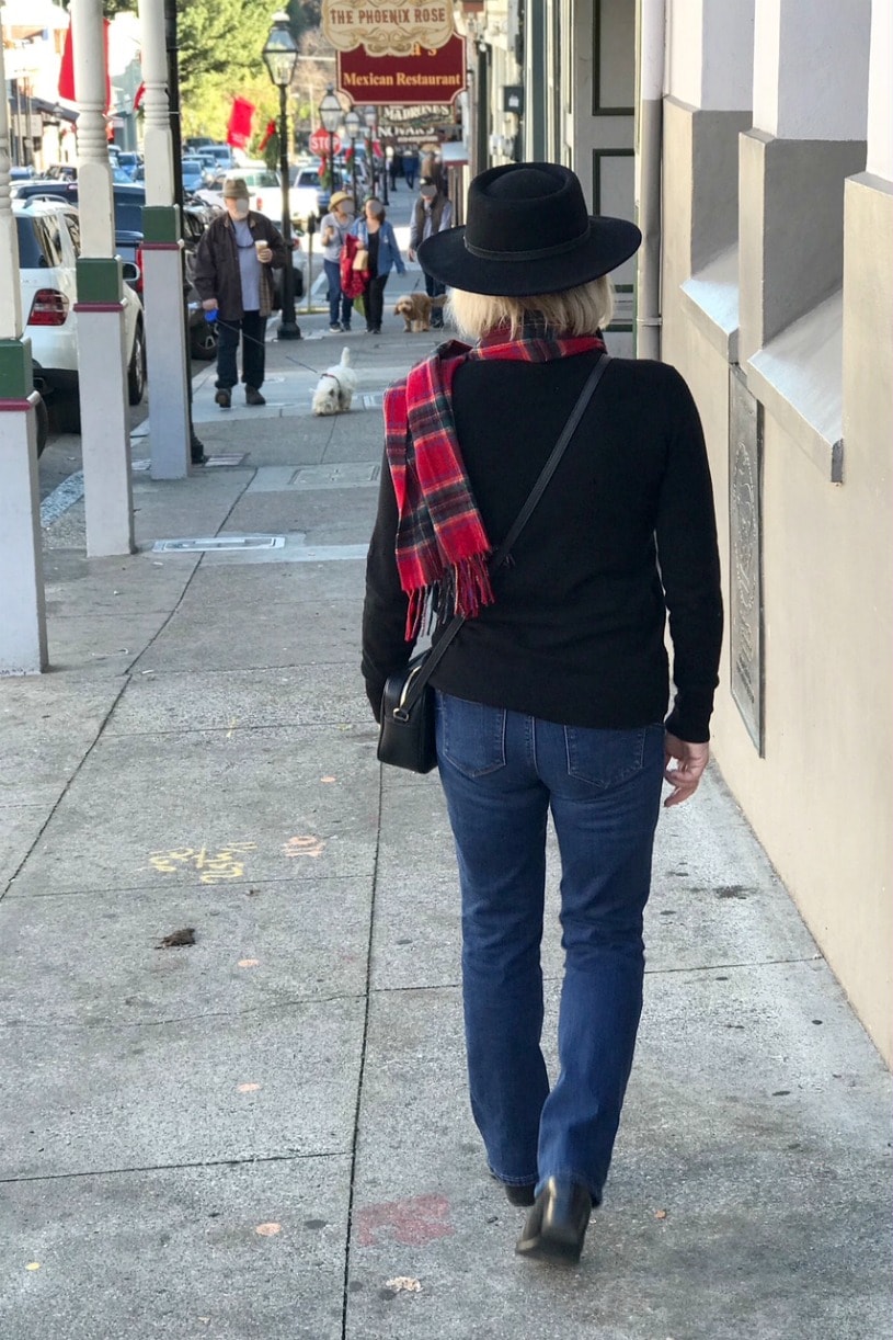 Jennifer Connolly of A Well Styled Life wearing plaid scarf and black fedora in Nevada City
