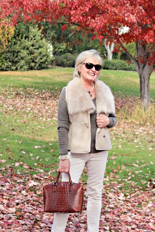 jennifer connolly of a well styled life styling a taupe faux fur vest and ivory jeans