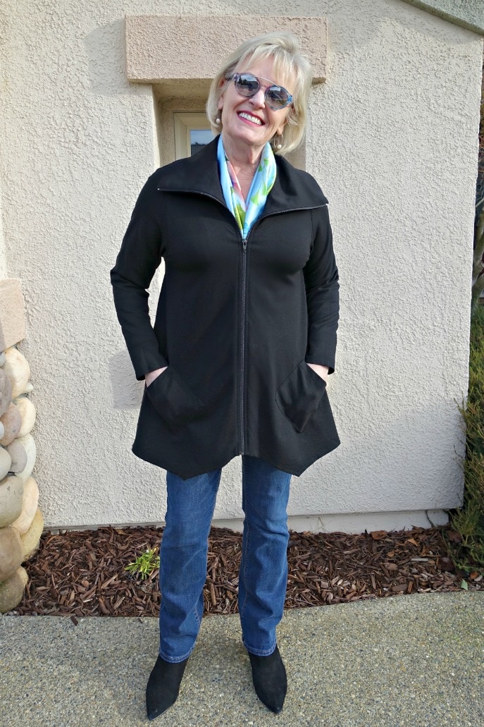 Jennifer Connolly of A Well Styled Life wearing a silk scarf in the neckline of a black jacket