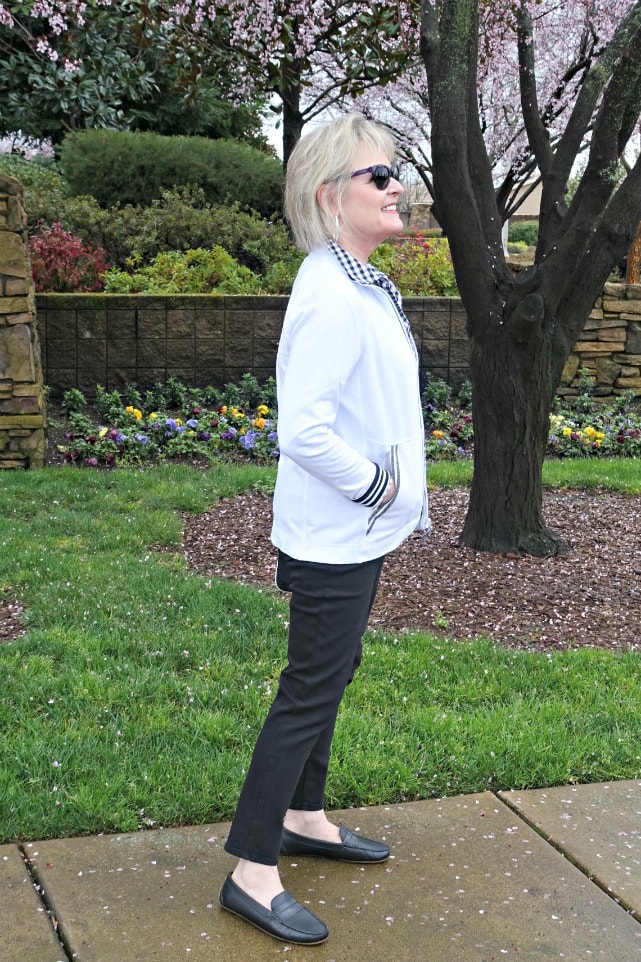 T Talbots yoga jacket and Talbots never fade black jeans on Jennifer Connolly in front of spring flowers