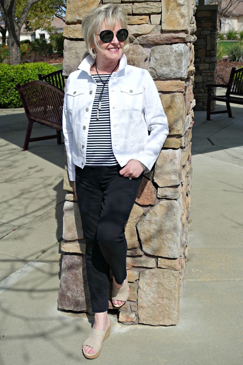 Jennifer Connolly of A Well Styled Life wearing Clarks Annadel Ivory wedge sandal with black jeans, white denim jacket and striped top
