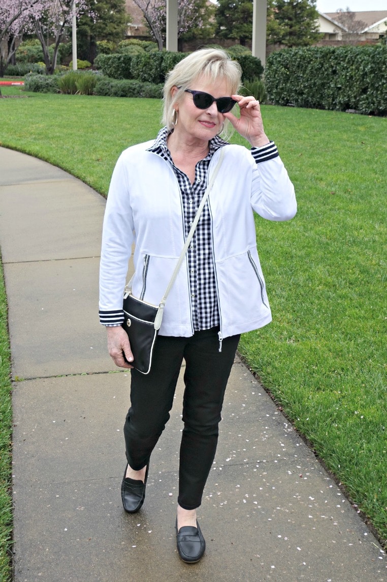Jennifer of A Well Styled Life wearing black and white shirt, black jeans, and black driving moccasin from Talbots
