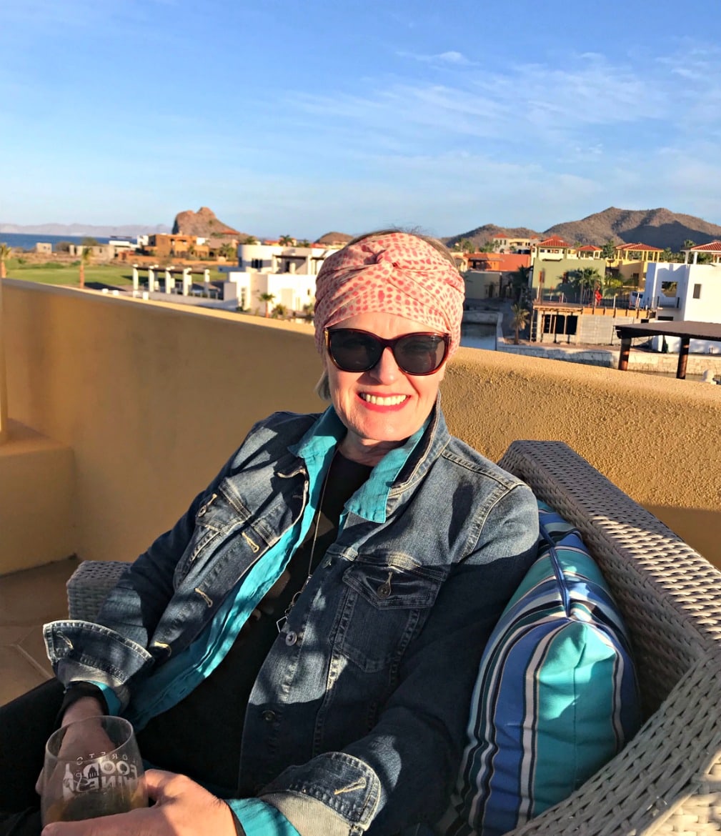 Jennifer Connolly of A Well Styled life wearing head wrap, denim jacket and linen shirt in tower at Loreto Bay