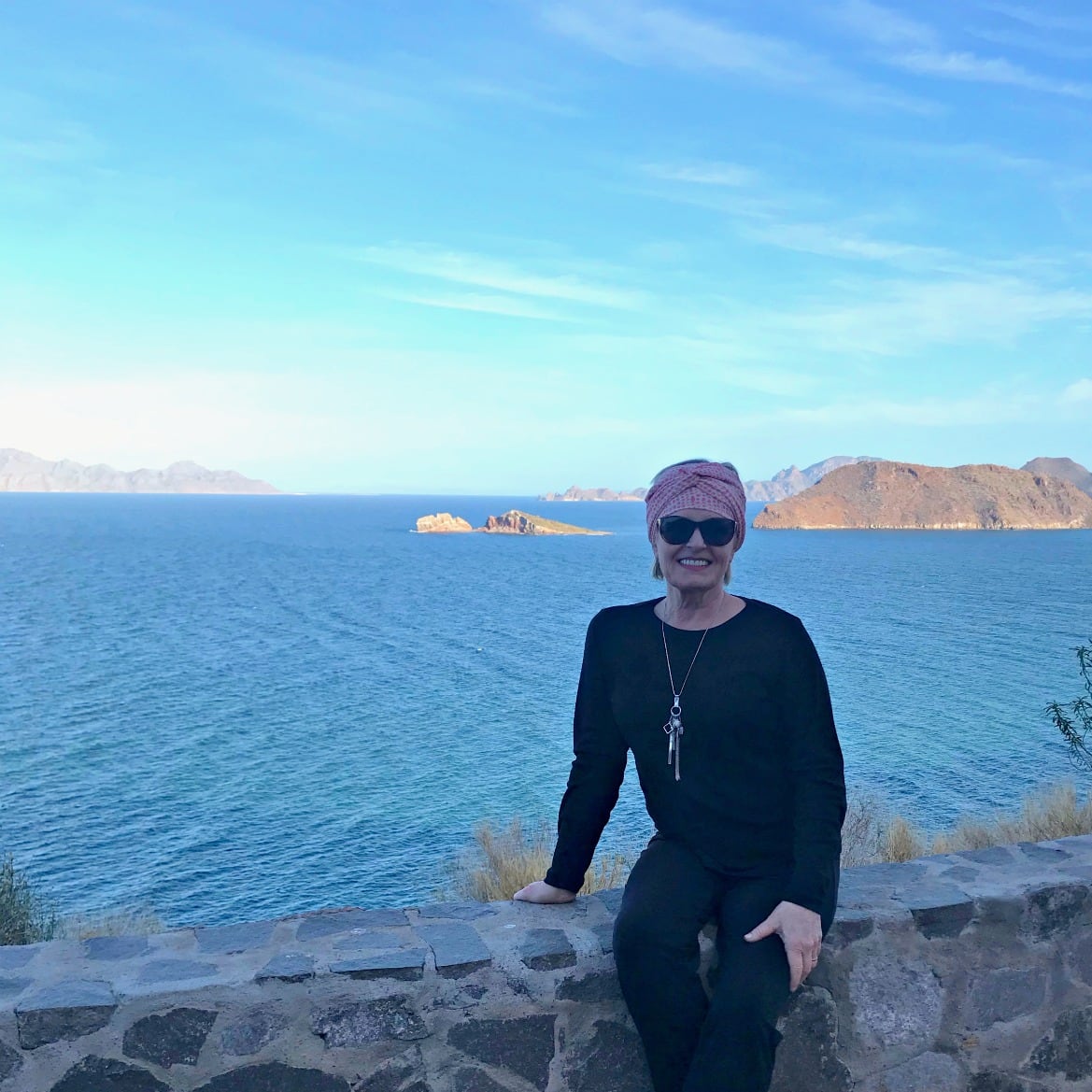Jennifer Connolly of A Well Styled Life on seawall at the Sea Of Cortez, Mexico