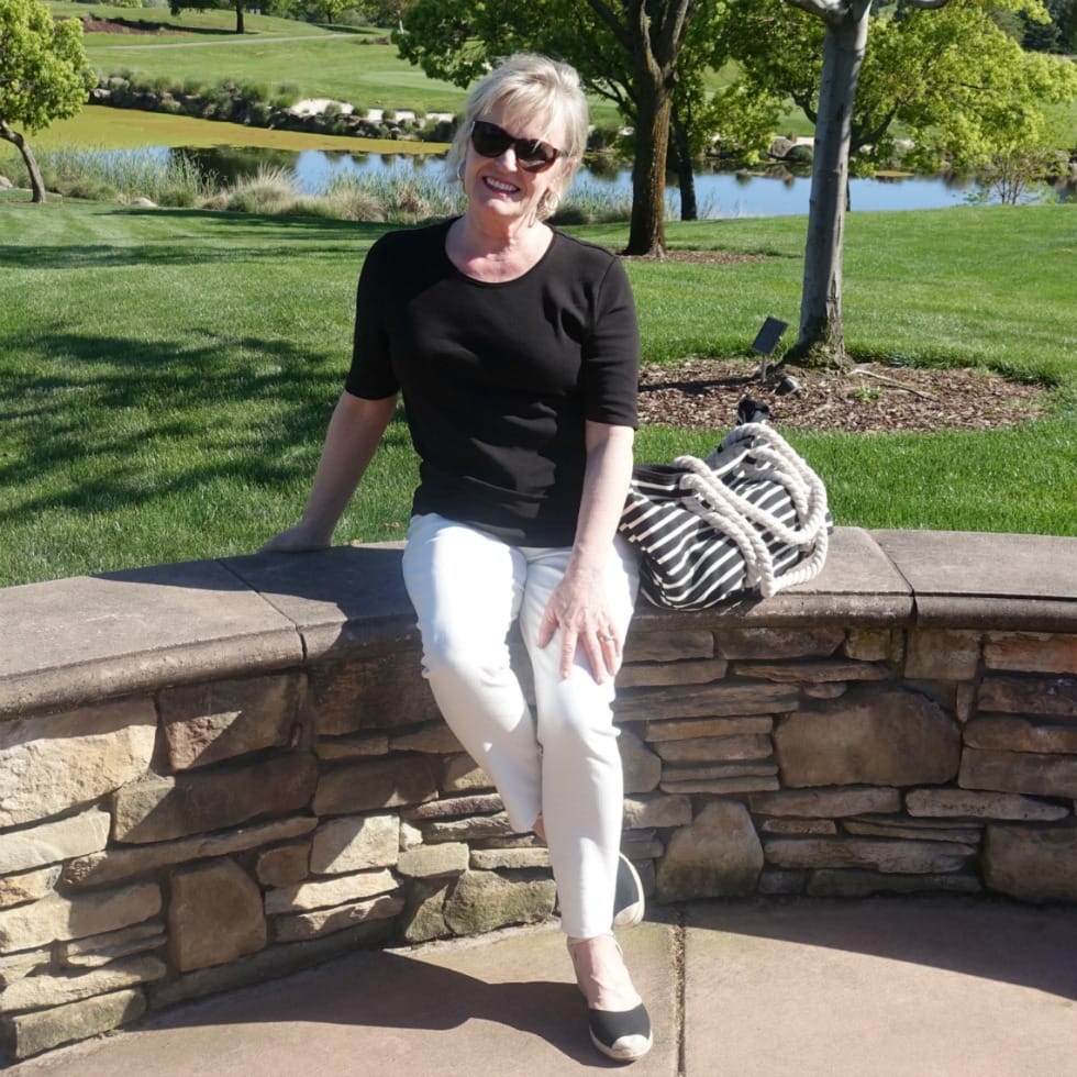 ivory colored jeand and black tee styled with black espadrilles and striped tote on Jennifer of A Well Styled Life