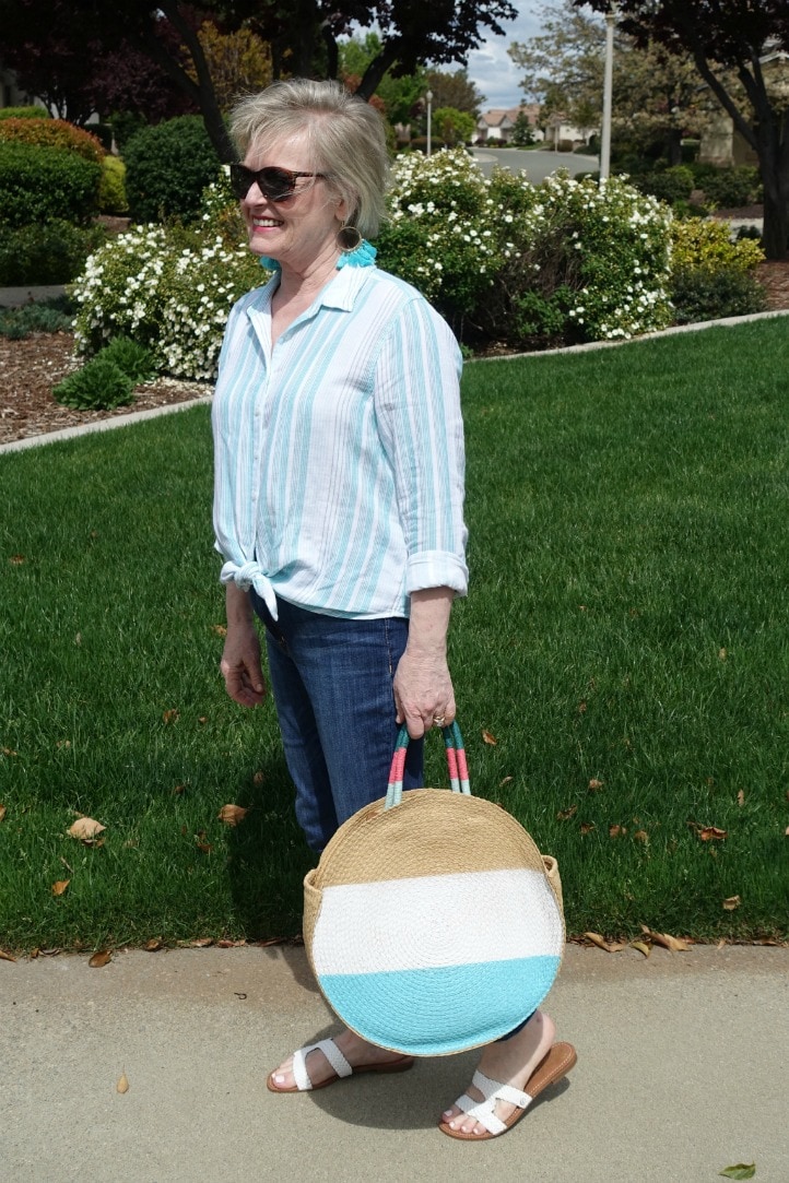 striped shirt and straw tote styled with blue jeans on Jennifer Connolly of A