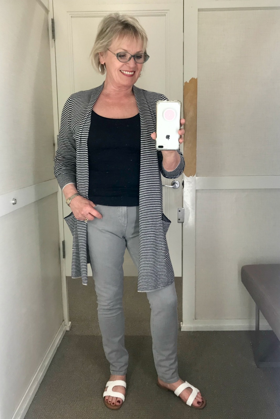 Jennifer of A Well Styled Life wearing a striped cardigan, gray skinny crop jeans from Loft