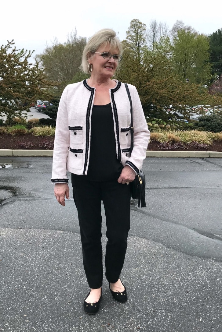 Jennifer Connolly of A Well Styled Life wearing tweed jacket over black jeans with ballet flats and cross body bag