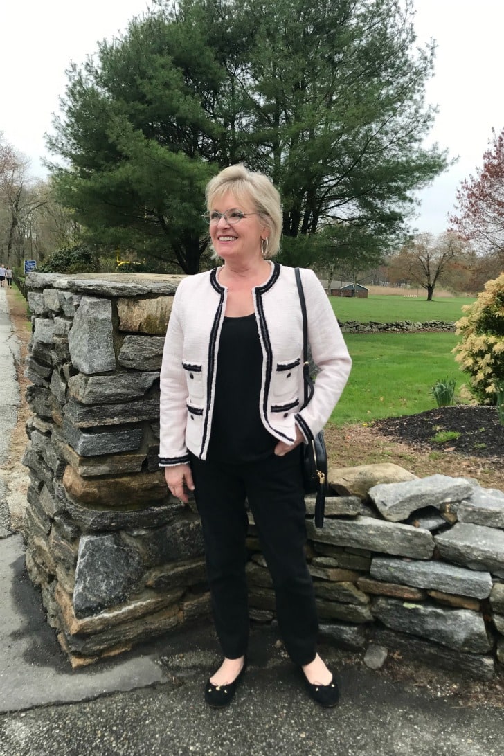 Jennifer Connolly wearing casual outfit of black jeans and tweed jacket with ballet flats for high school reunion