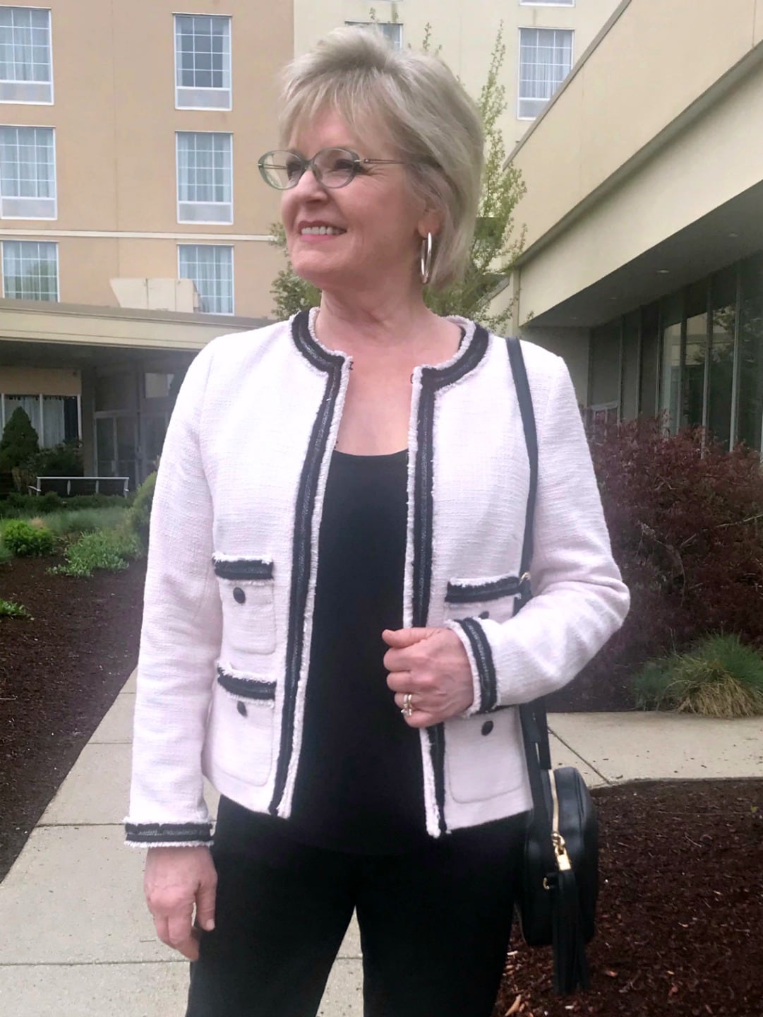 Jennifer Connolly of A Well Styled Life wearing silver hoop earings and tweed Chanel-type jacket