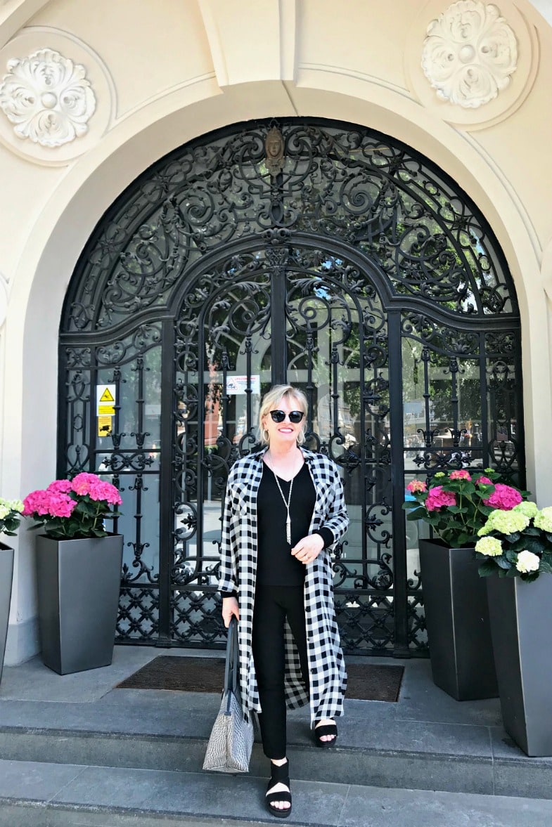 Jennifer Connolly of A Well Styled Life wearing black andc white checked duster over colum n of black