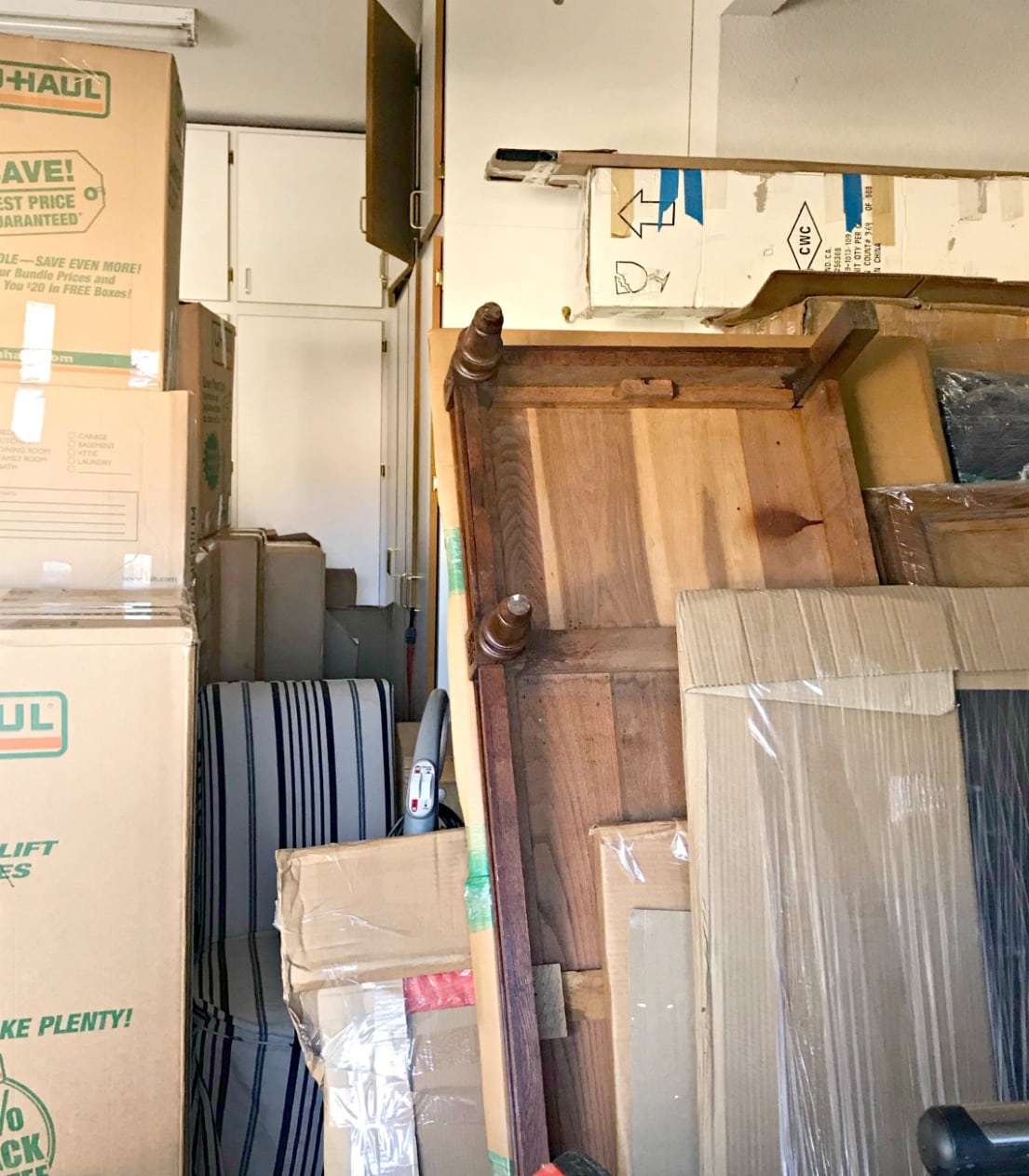 boxes and antique armoire pieces in garage