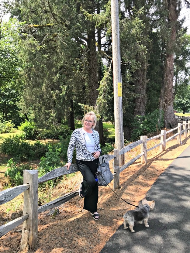 Jennifer Connolly of A Well Styled Life at a rest stop wearing leopard cardigan with white tee and black lantern pants