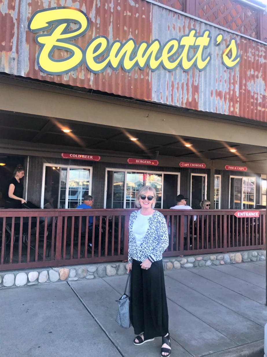 Jennifer Connolly of A Well Styled Life dressed for RV travel wearing leopard cardigan from Banana Republic with black knit pants a Eileen Fisher sport sandals