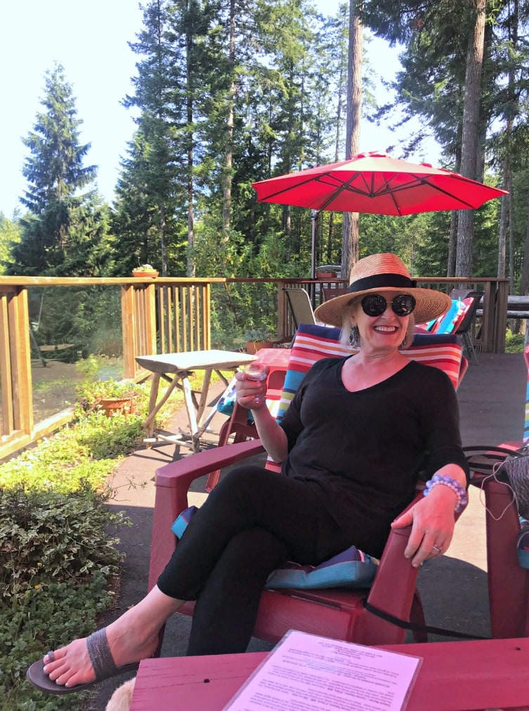 Jennifer Connolly of A Well Styled Life wearing all black casual outfit with straw hat