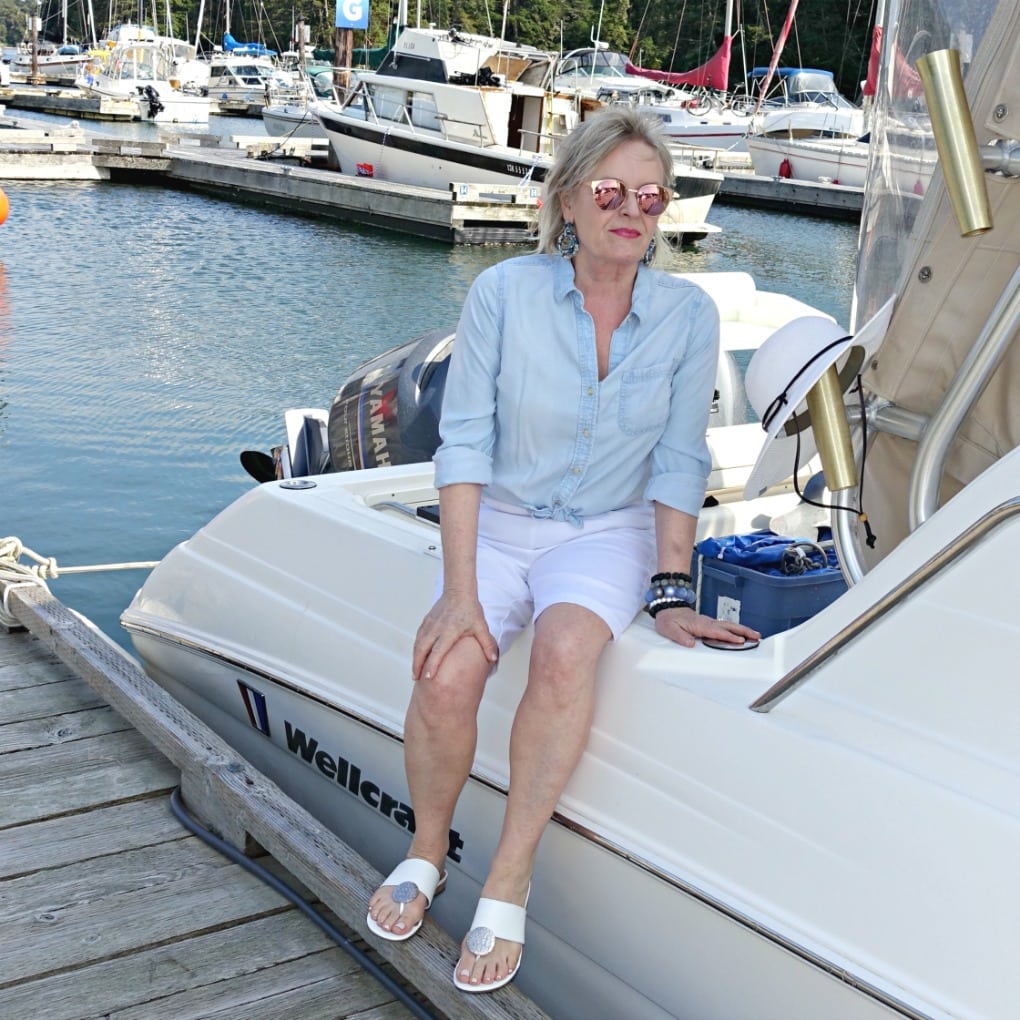 Jennifer Connolly of A Well Styled Life wearing Walmart shorts and denim shirt on boat