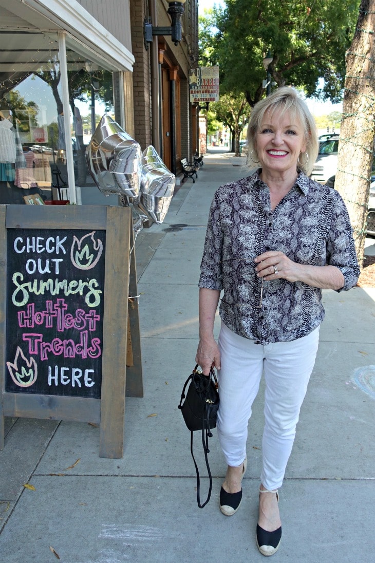 Jennifer Connolly of A Well Styled Life on casual white jeans with snakeprint blouse and black esparilles