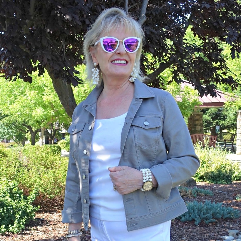 Jennifer Connolly of A Well Styled Life wearing classic denim jacket in stone color from Talbots and white tassel earrings