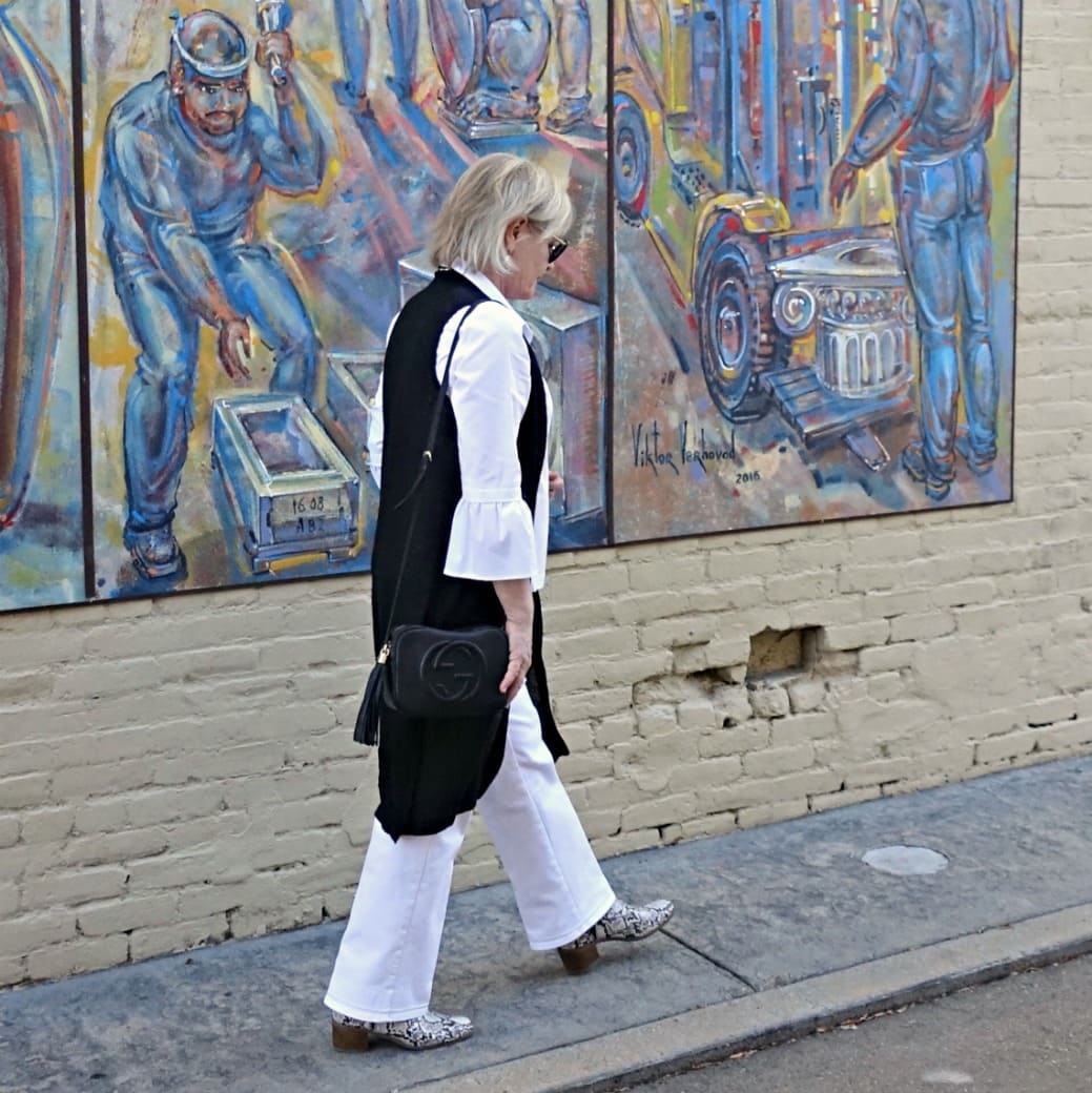 Jennifer Connolly of A Well Styled life wearing black linen vest over white jeans and shirt