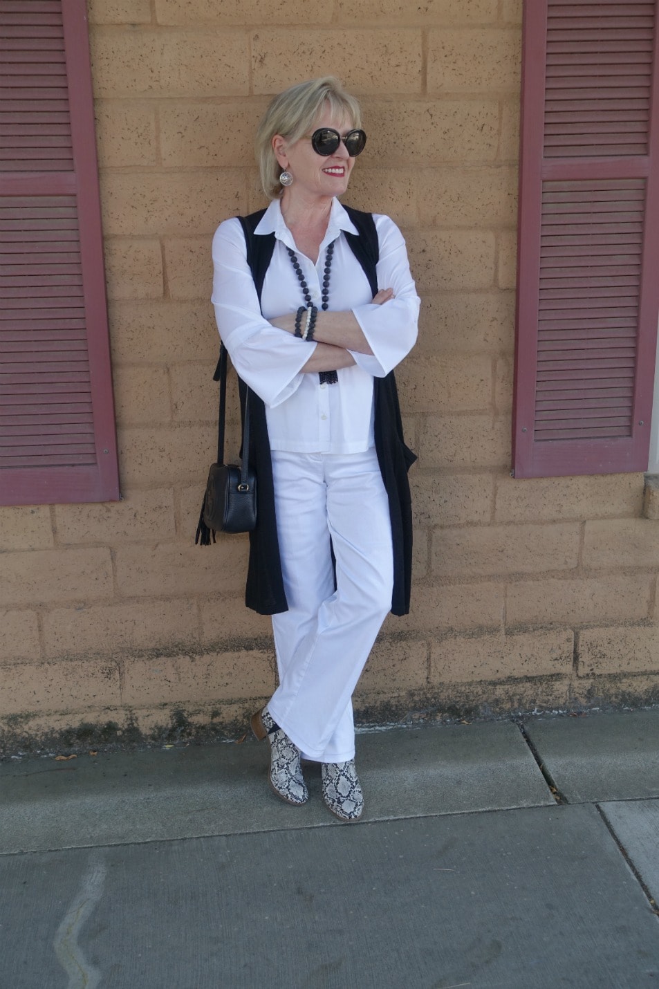 Jennifer Connolly of A Well Styled life wearing casual colmn of white and snake print booties