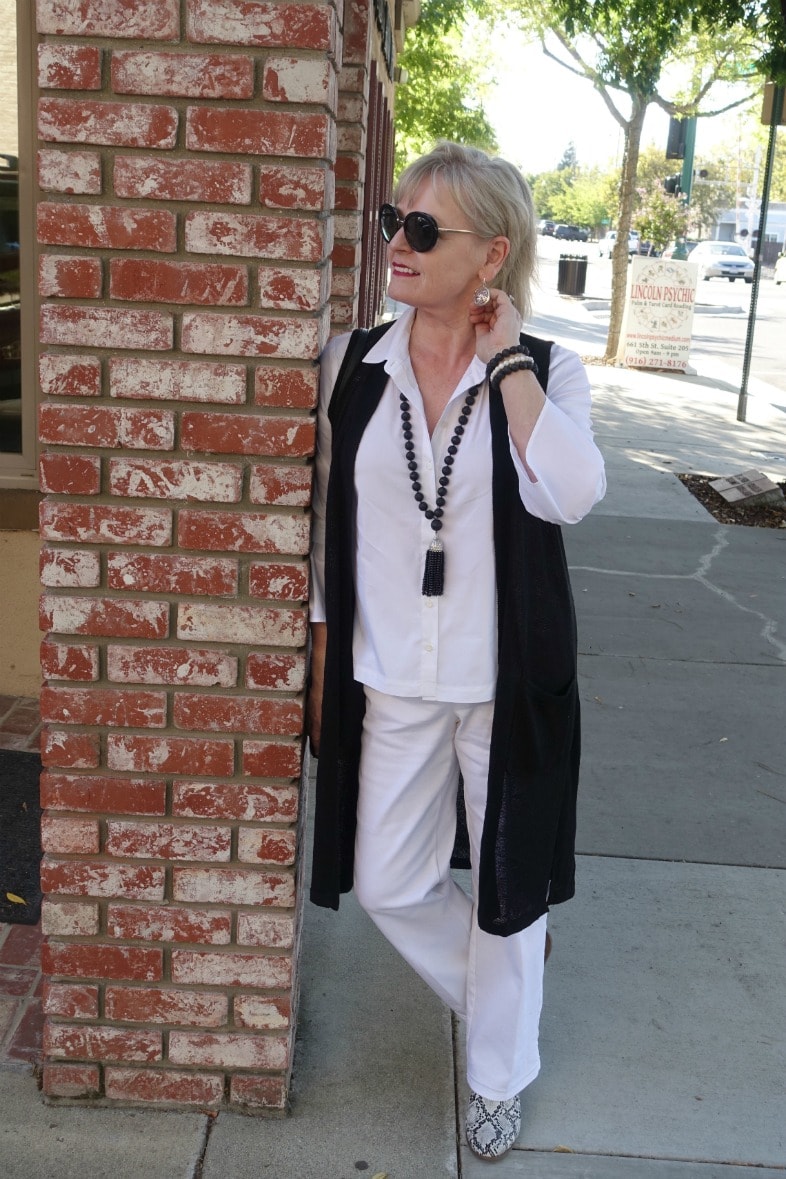 Jennifer Connolly of A Well Styled Life wearing a column of white with black vest from j.jill.