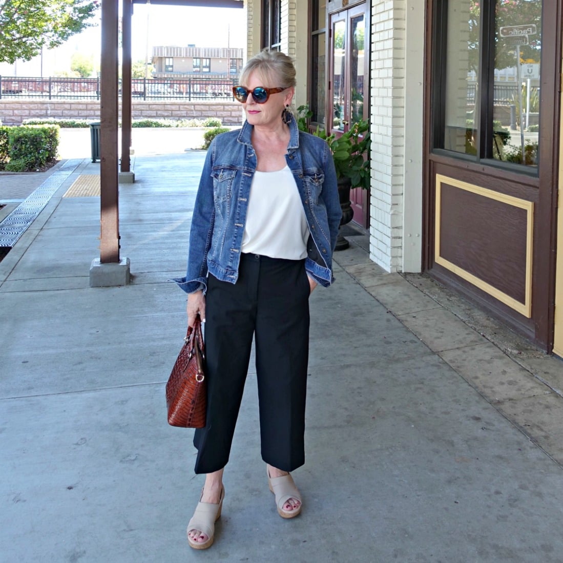 casual outfit of denim jacket and black crops on Jennifer Connolly of A Well Styled Life