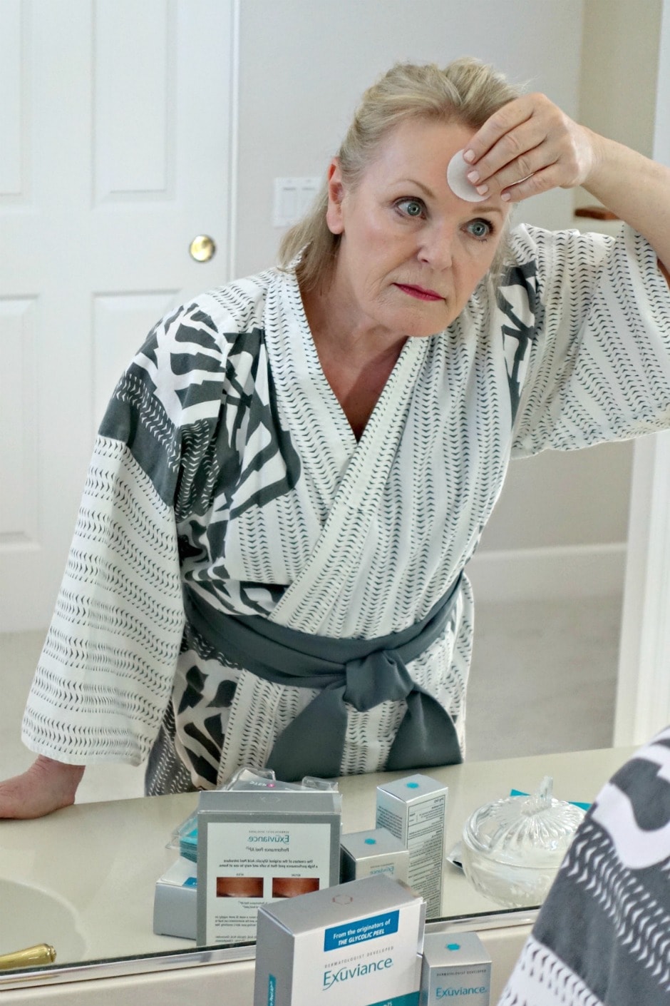 Jennifer Connolly of A Well Styled life applies Exivuance exfoliating pad to her forhead