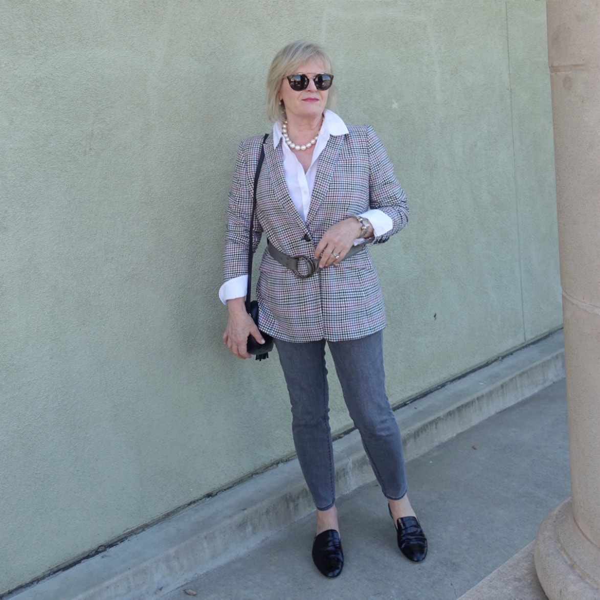 Jennifer Connolly of A Well Styled Life wearing a plaid blazer with belt over skinny gray jeans from Talbots