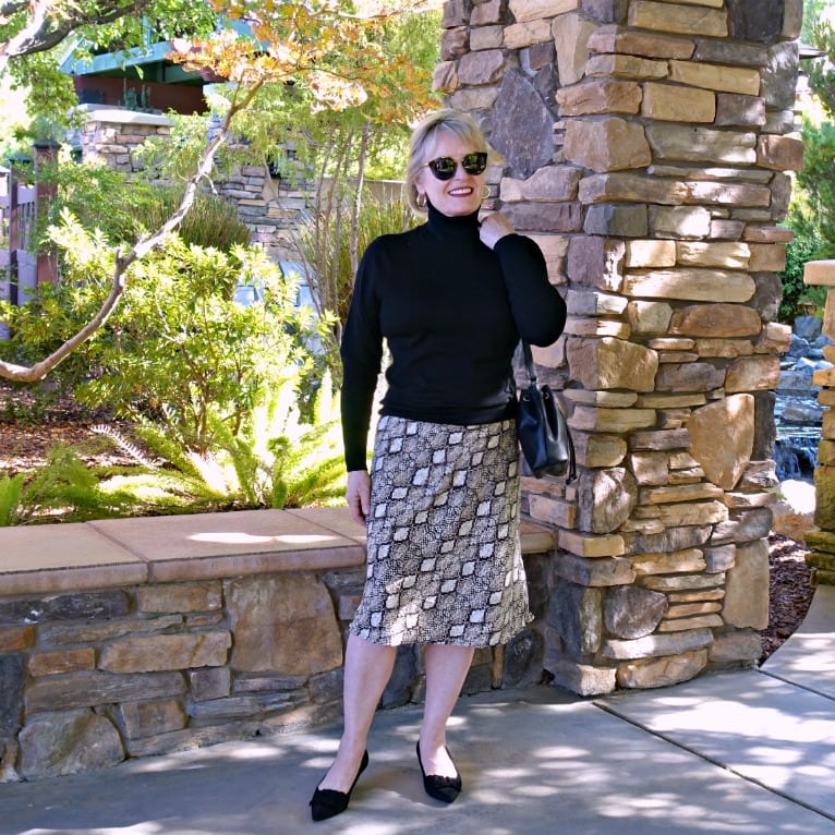 Jennifer Connolly wearing midi skirt and turtleneck sweater