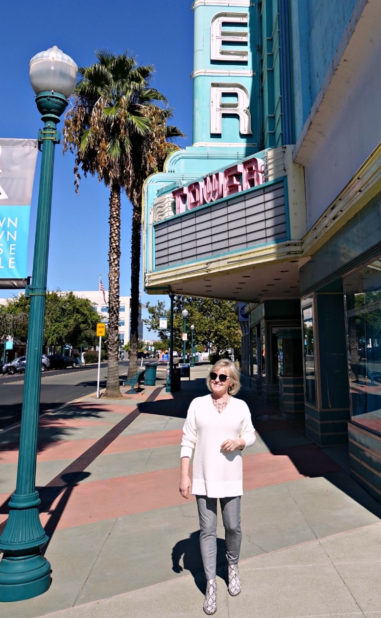 Jennifer Connolly of A Well Styled Life in front of vintage movie theater