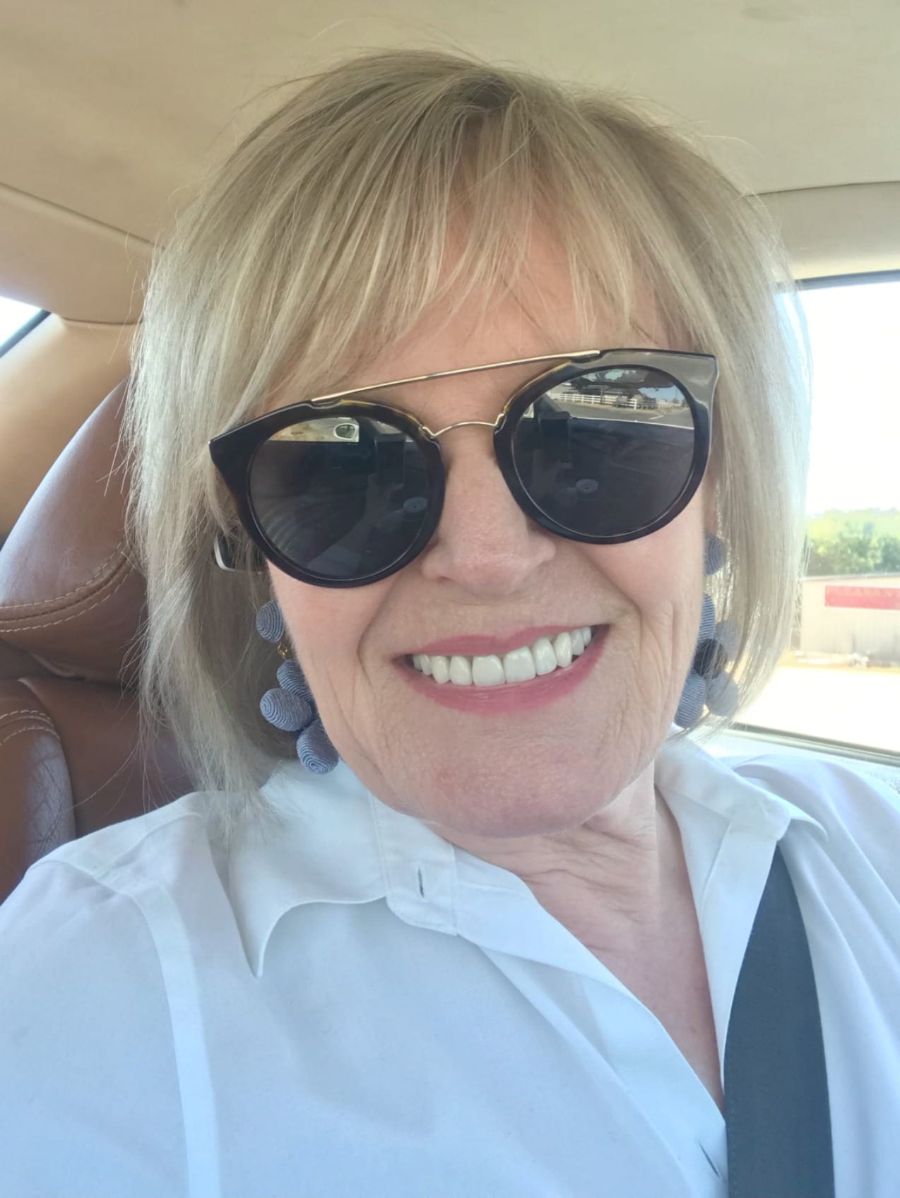 Jennifer Connolly of A Well Styled Life wearing white shirt and sunglasses