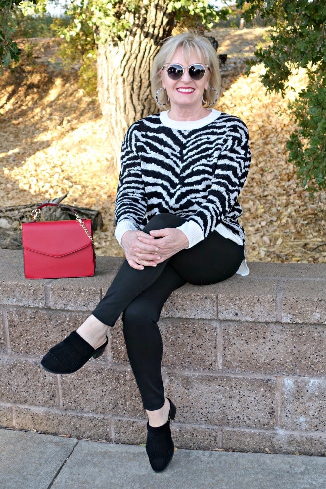 Jennifer Connolly of A Well Styled Life wearing leopard sweater with red handbag