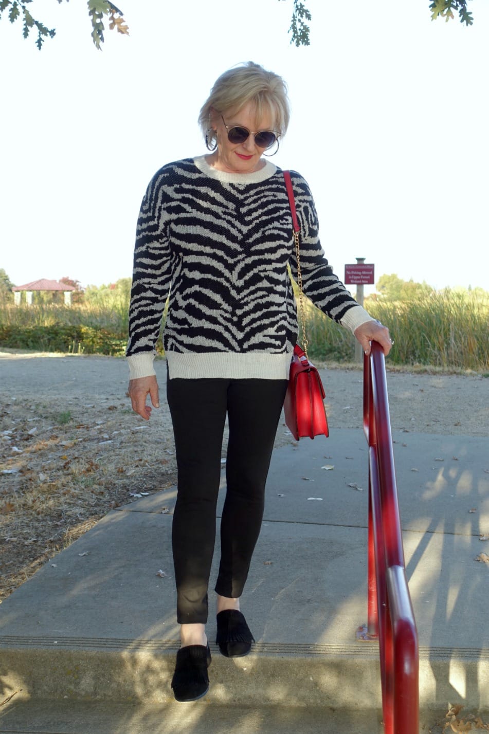 Jennifer Connolly of A Well Styled Life wearing zebra sweater with black leggings