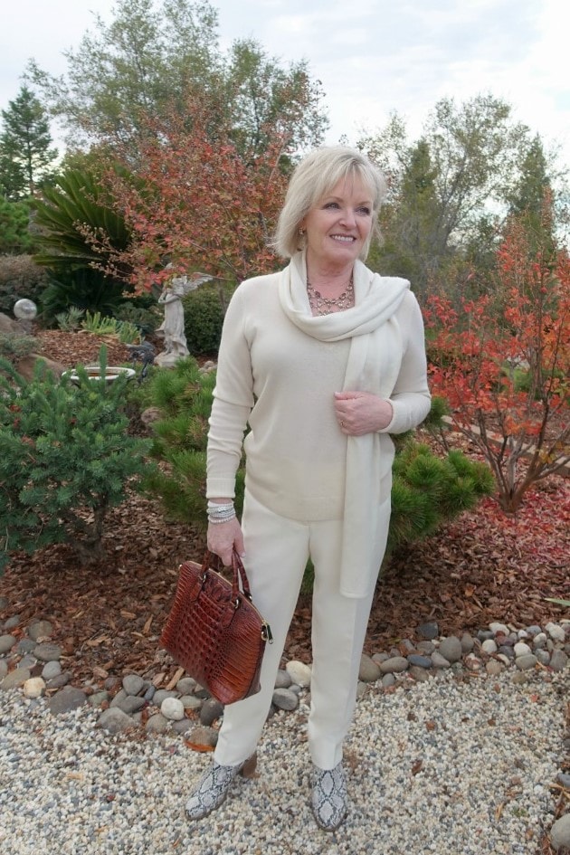 Jennifer Connolly wearing Everlane cashmere sweater and scarf in a column of ivory