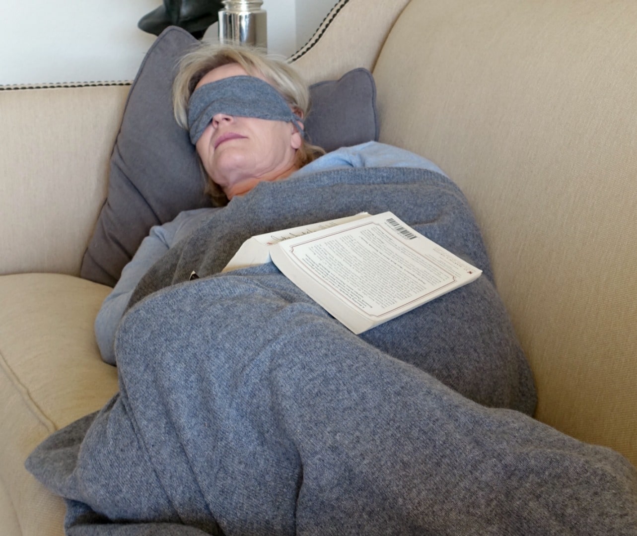 Jennifer Connolly napping with Cashmere Boutique travel set on her couch