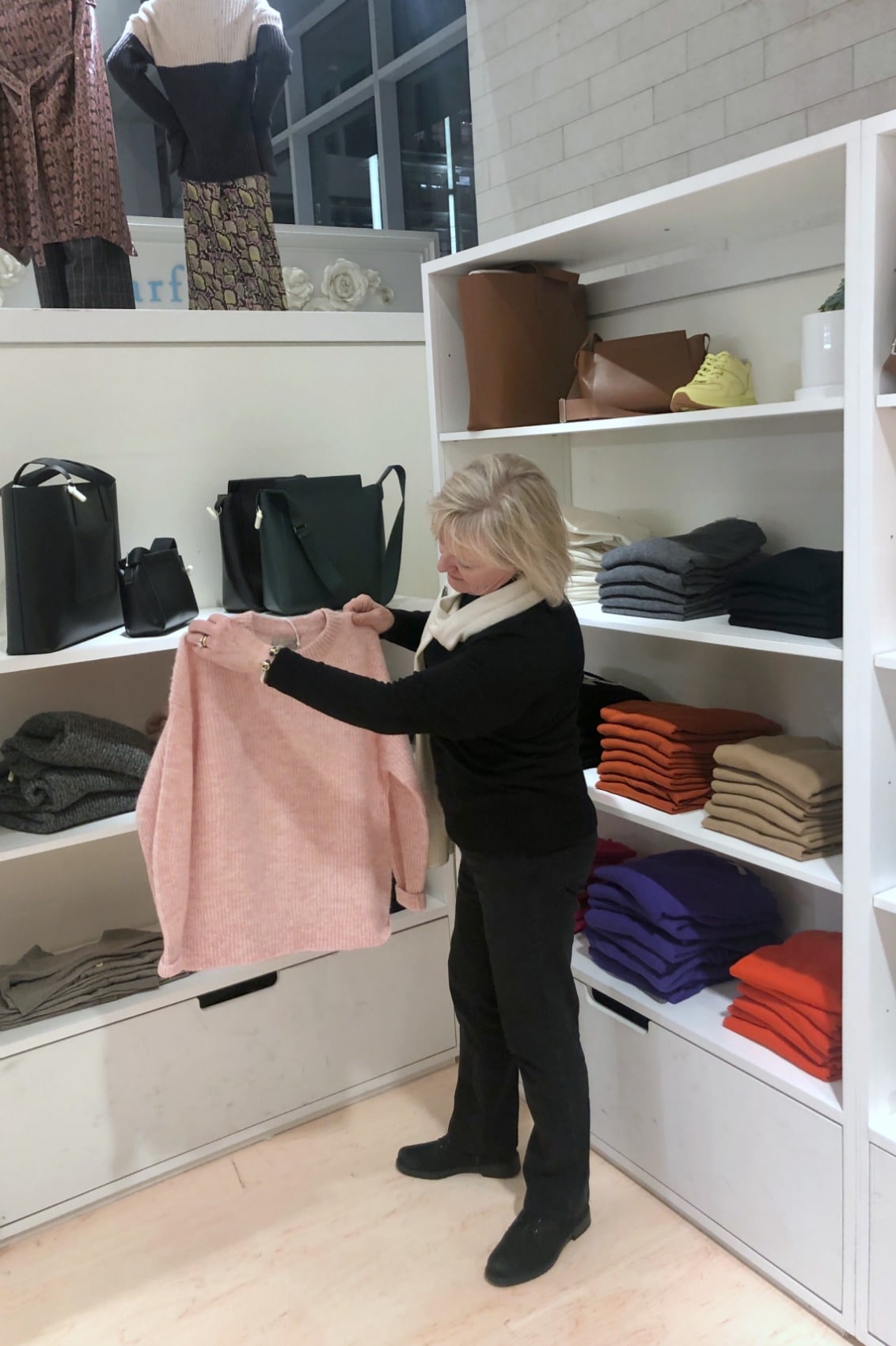 Jennifer Connolly of A Well Styled Life wearing black sweater, jeans and boots
